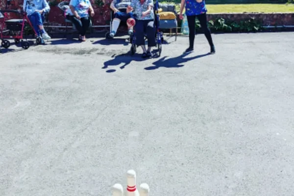 Residents playing a game of skittles outside in the sunshine