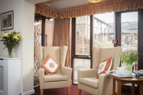 A sunny lounge with armchairs overlooking the garden